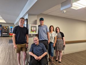 Members of the Otto family with West Perth Village staff and a resident beside the newly installed defibrillator cabinet